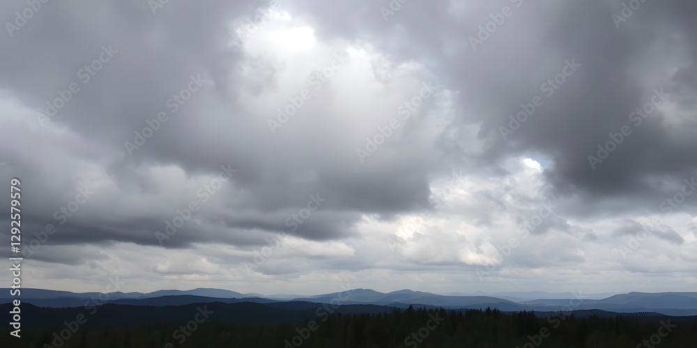 Fototapeta premium Heavy Clouds Moving Over a Forest with Thick Trees and Rolling Hills in the Distance