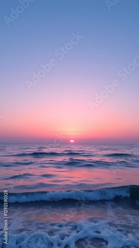  Soft Pink and Blue Sunset Over a Calm Ocean with Gentle Waves