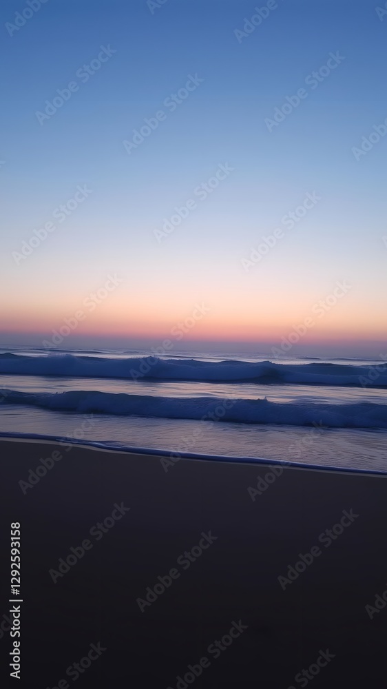 Twilight by the Sea, Waves Gently Rolling and a Faint Pink Horizon Illuminating the Beach with Soft Light Twilight by the Sea, Waves Gently Rolling and a Faint Pink Horizon Illuminating the Beach with Soft Light