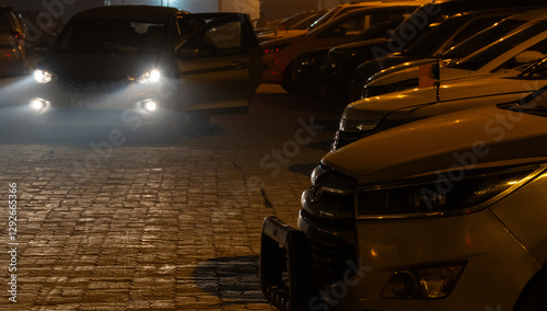 Nighttime Parking Lot – Headlights and Shadows