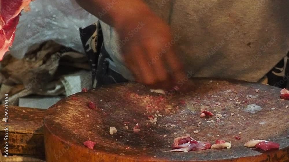 Butcher Cutting Meat on Wooden Board in Market Butcher Cutting Meat on Wooden Board in Market