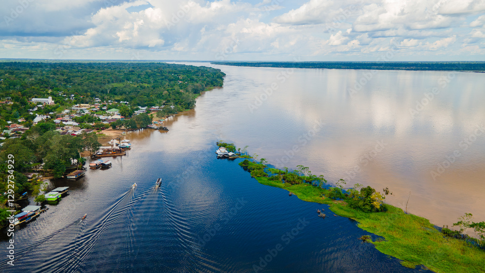 Obraz premium Aerial View of the Amazon River in Colombia with Lush Rainforest and Local Community