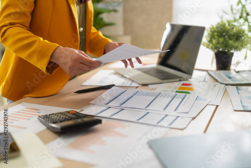 Canvas Print businesswoman hand closeup Deciphering some business data graph charts and lapto