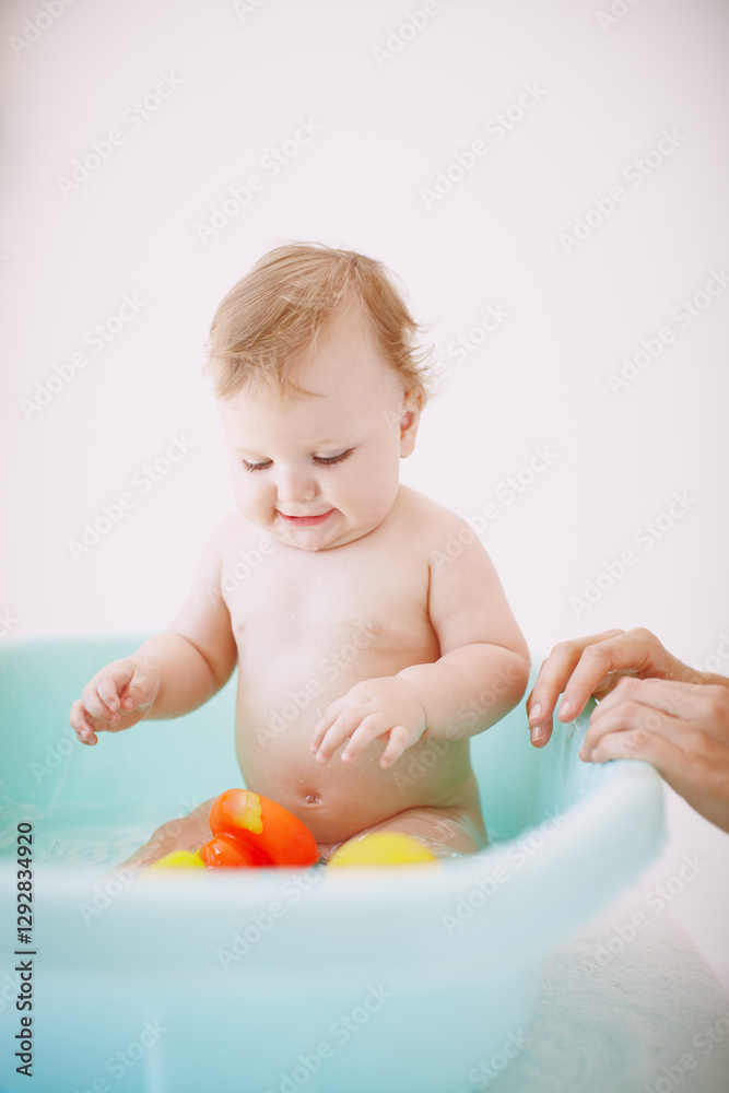 Happy, toys and baby in bath for cleaning, washing and hygiene routine for wellness in home. Family, development and young child in bathtub with water, soap and foam for cleanse, health and playing Happy, toys and baby in bath for cleaning, washing and hygiene routine for wellness in home. Family, development and young child in bathtub with water, soap and foam for cleanse, health and playing