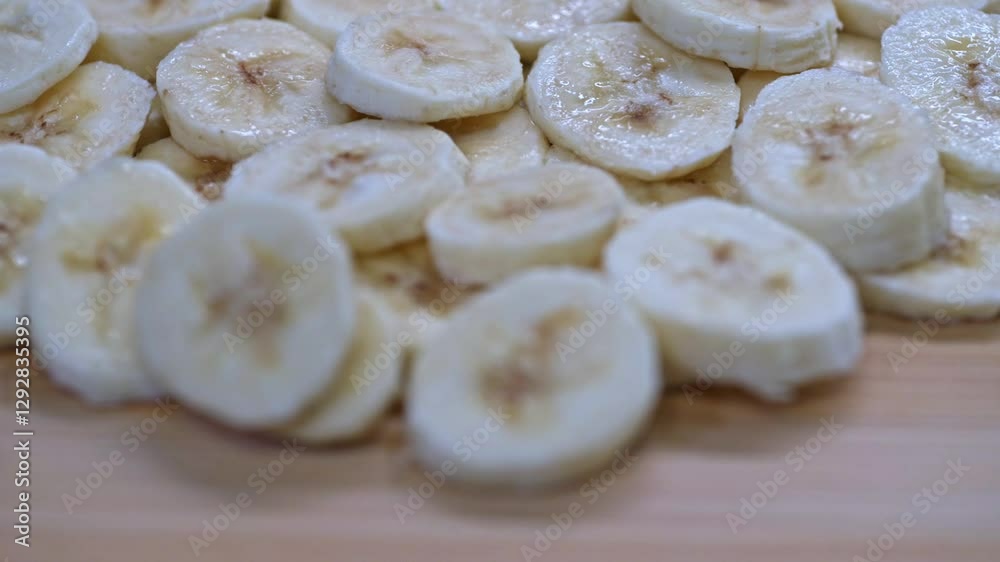 A close-up view of freshly sliced bananas on a wooden table.