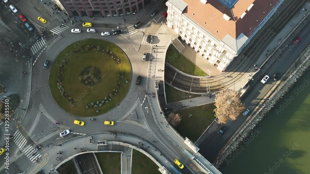 Aerial top down overview of a Budapest roundabout with traffic and pedestrians