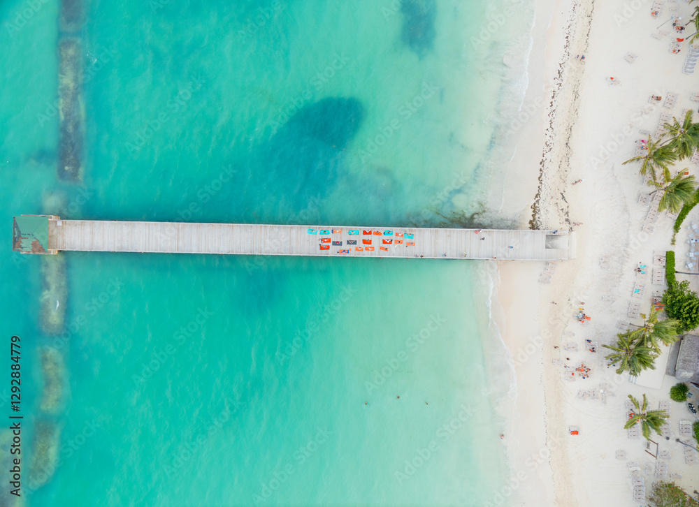A beautiful beach with a pier and a pier with a lot of colorful chairs