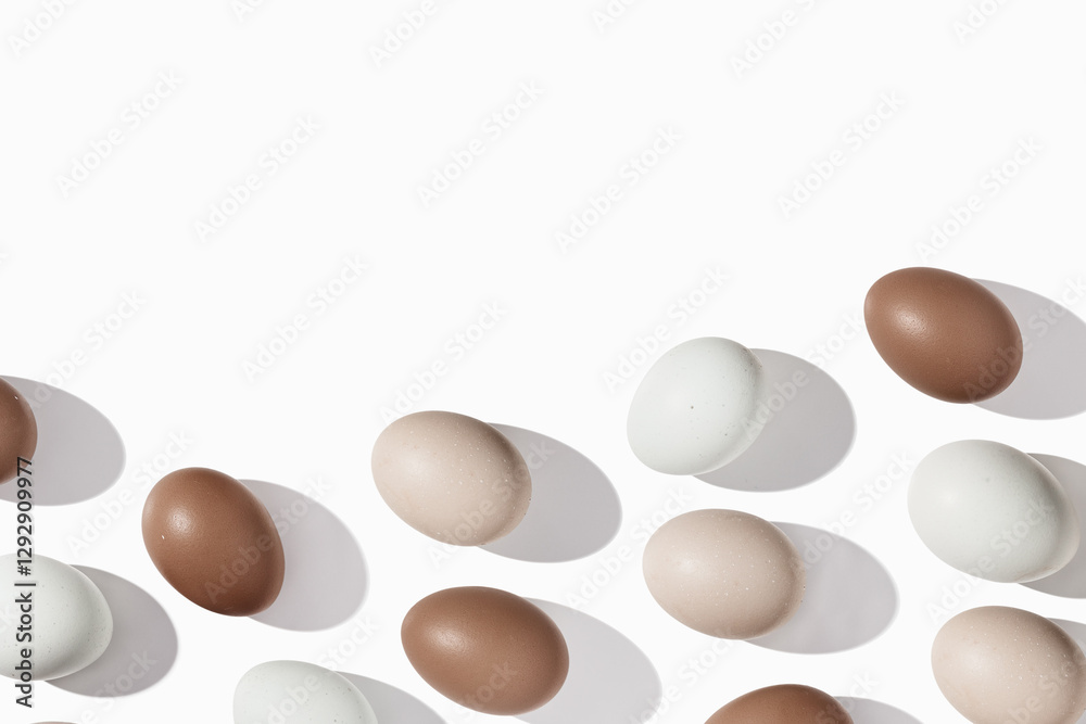 Pattern of Brown and beige Eggs with sun shadows, minimal aesthetic holiday background, natural organic chicken eggs, breakfast ingredients, minimalist food composition, copyspace Pattern of Brown and beige Eggs with sun shadows, minimal aesthetic holiday background, natural organic chicken eggs, breakfast ingredients, minimalist food composition, copyspace