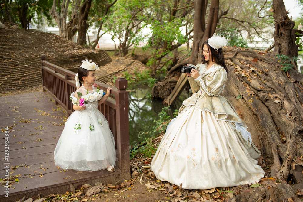 Two sister wearing vintage clothes are having fun happily in a large garden house.