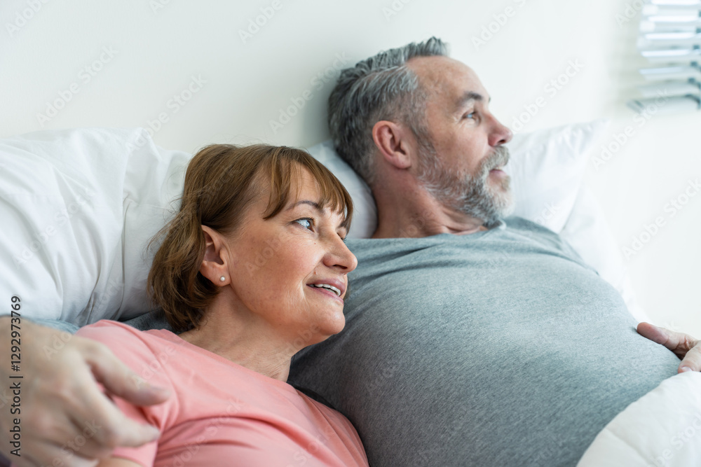 Caucasian senior older couple lying down on bed after wake up in house. Caucasian senior older couple lying down on bed after wake up in house.