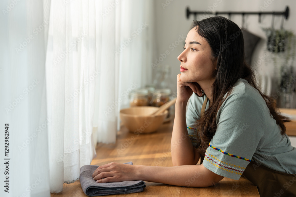 Asian fatigued cleaning service woman worker cleaning kitchen at home. Asian fatigued cleaning service woman worker cleaning kitchen at home.