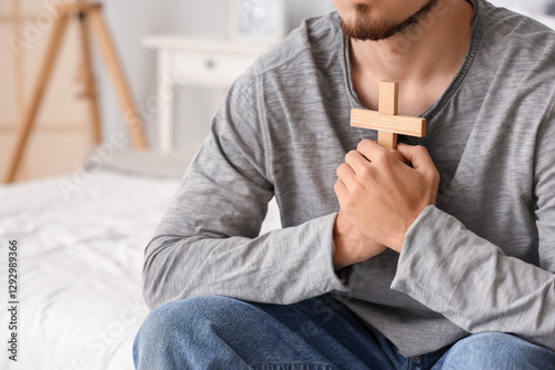 Young man with wooden cross...