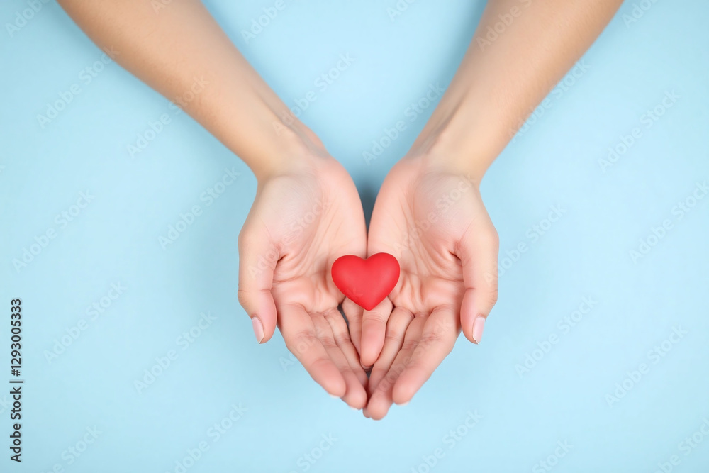 Obraz premium group of people holding a red heart in their hands