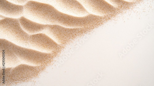 Close-up of sand ripples on a beige surface, forming abstract natural patterns.