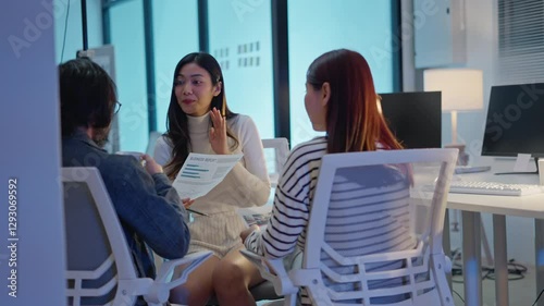 group of Happy young asian business people chatting happily after a night of overtime work in the office.Supervisor chats with employees after working together planning success strategy enjoy teamwork