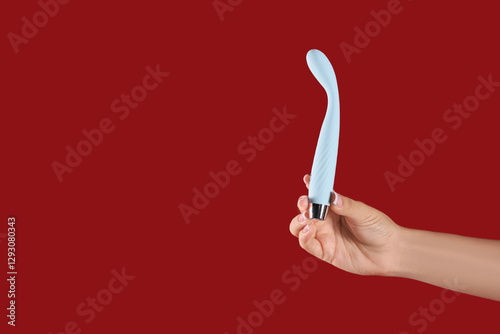 Woman with vibrator on red ...