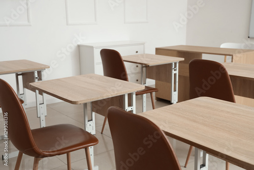 Interior of empty classroom with school desks