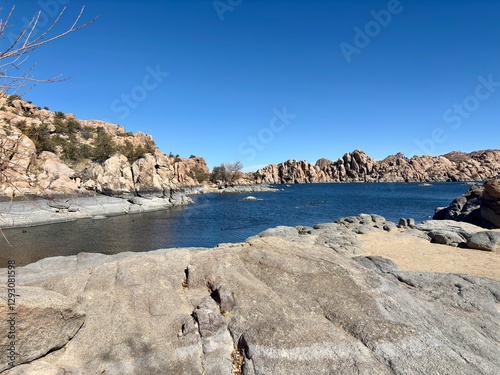 Rocky shoreline of Watson Lake in Prescott, Arizona, under clear sky photo