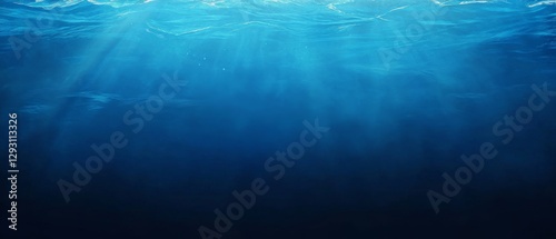 A blue ocean with a light shining on it