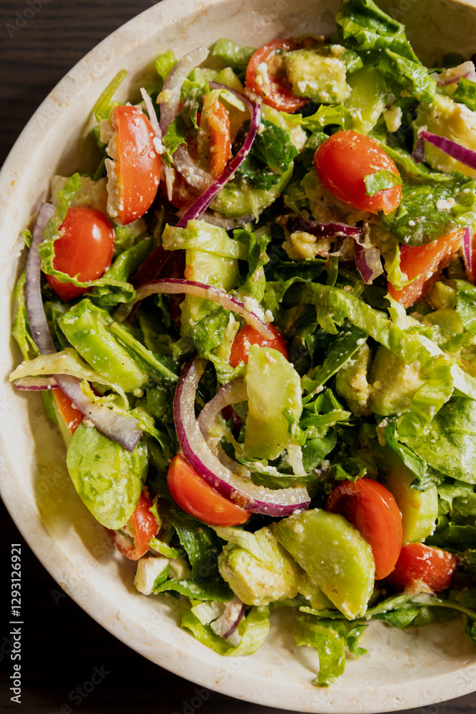 fresh delicious spring salad with lettuce, tomato, cucumber, and feta cheese close-up fresh delicious spring salad with lettuce, tomato, cucumber, and feta cheese close-up