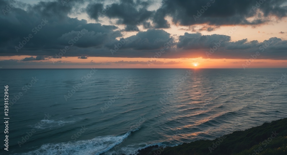 Fototapeta premium Tranquil Sea Landscape at Sunset with Dramatic Clouds and Gentle Waves Reflecting Glowing Horizon Over Calm Waters