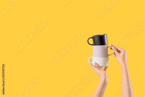 Female hands holding stacke...