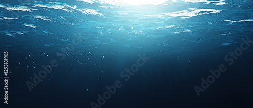 A blue ocean with a lot of bubbles and a lot of light shining through the water