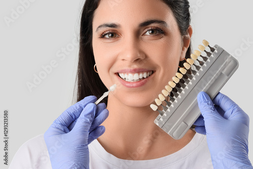 Dentist with teeth color sa...