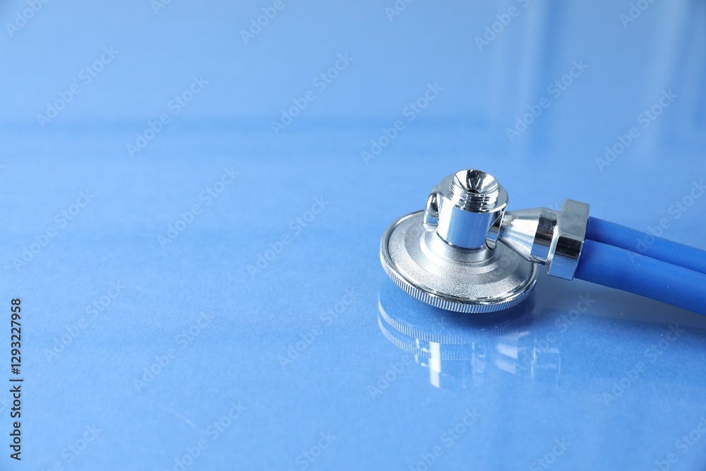Obraz premium Stethoscope on blue background, closeup. Space for text