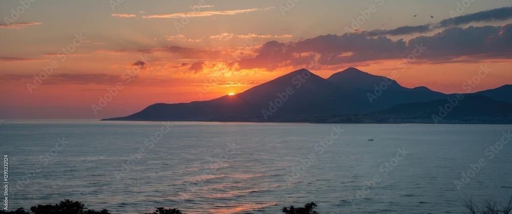Serene Sunset Over Calm Sea with Majestic Mountains in the Background Illuminated by Warm Orange and Pink Sky Hues Serene Sunset Over Calm Sea with Majestic Mountains in the Background Illuminated by Warm Orange and Pink Sky Hues