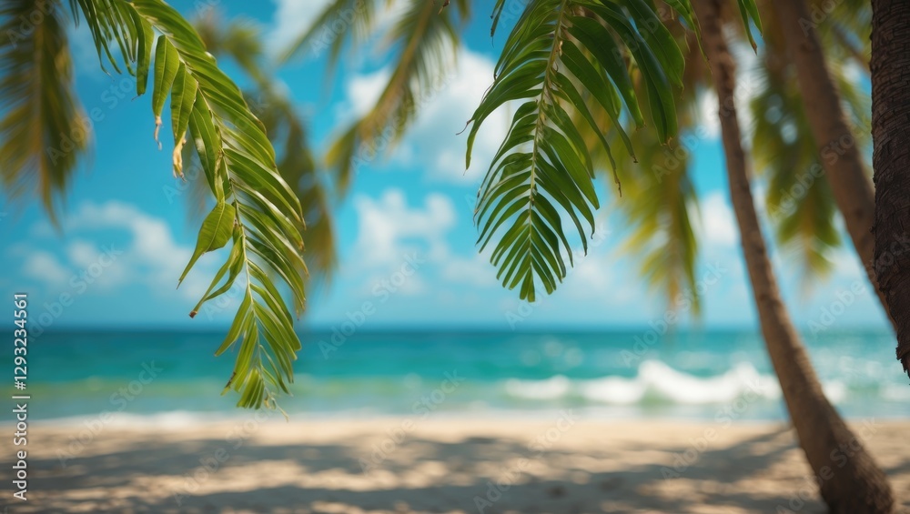 Fototapeta premium Tropical Beach Scene with Coconut Leaves Framing Blurry Seascape and Blue Sky Ideal for Summer Vacation and Travel Concepts