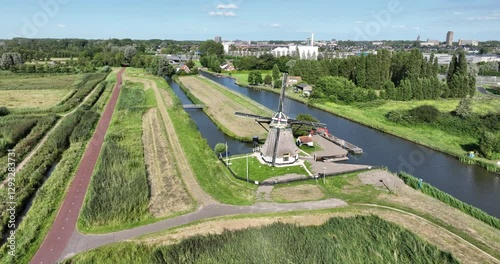 The Schaapweimolen also Schaapsweimolen polder mill of the ground-sailer type in the Dutch town of Rijswijk South Holland . The Netherlands. Aerial drone view. photo