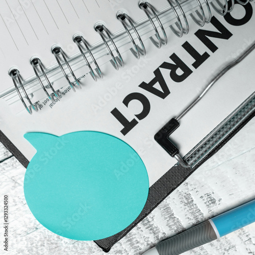 Color paper in shape of dialog box with important message. Infromation written on sticker. Different office stationery. Calculator, pencils, pens laing white table.