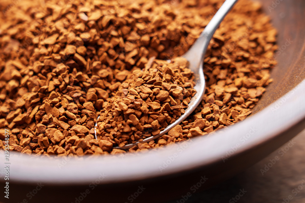 Metal spoon of instant coffee granules. Roasted organic soluble ingredient of aromatic traditional drink in wooden bowl. Energy boost and refreshment concept. Macro shot Metal spoon of instant coffee granules. Roasted organic soluble ingredient of aromatic traditional drink in wooden bowl. Energy boost and refreshment concept. Macro shot