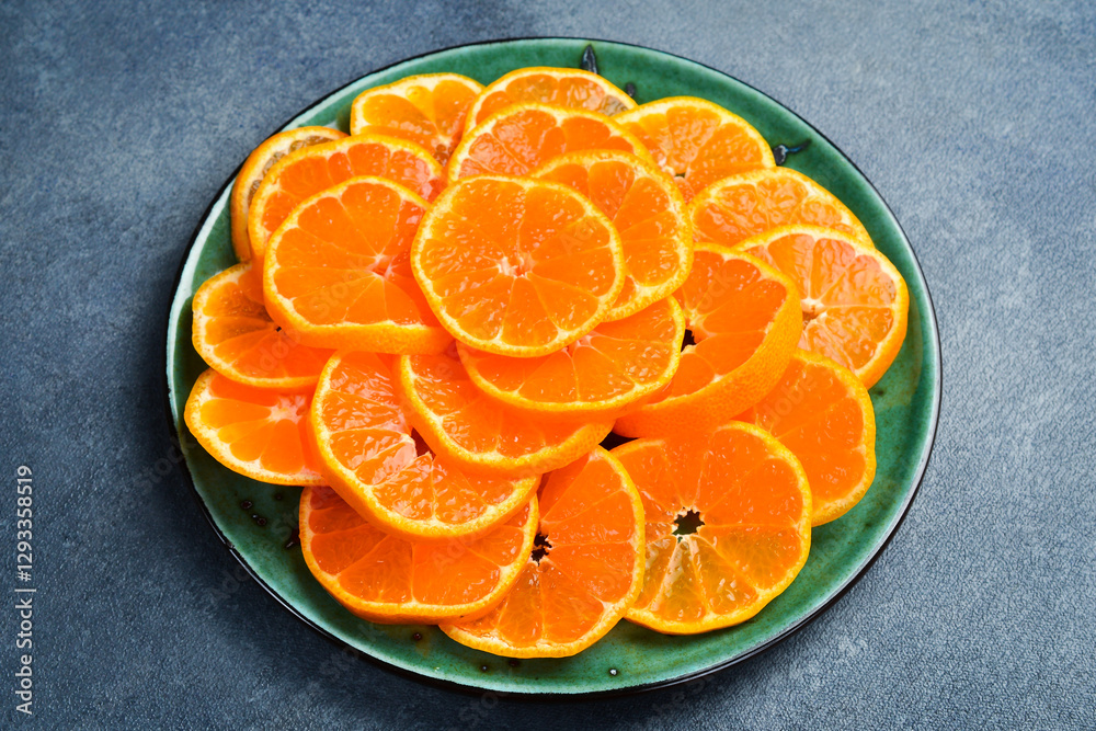 Cut mandarin slices on a plate are ready to eat. Close up macro, top view. Cut mandarin slices on a plate are ready to eat. Close up macro, top view.