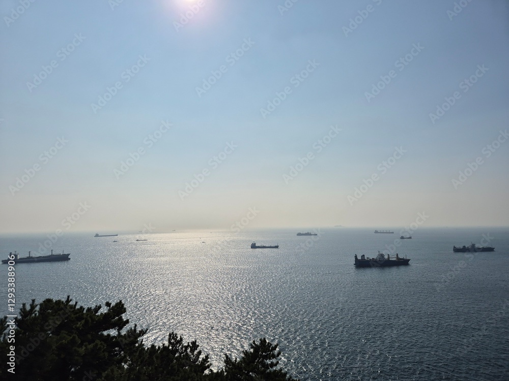 Sunlit Ocean with Cargo Ships on the Horizon Sunlit Ocean with Cargo Ships on the Horizon