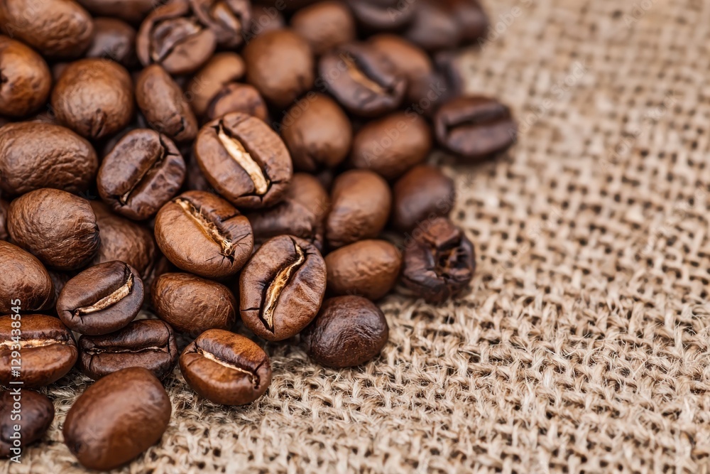 Roasted coffee beans on burlap sack. Close up. Concept of coffee, freshness, and aroma. Roasted coffee beans on burlap sack. Close up. Concept of coffee, freshness, and aroma.