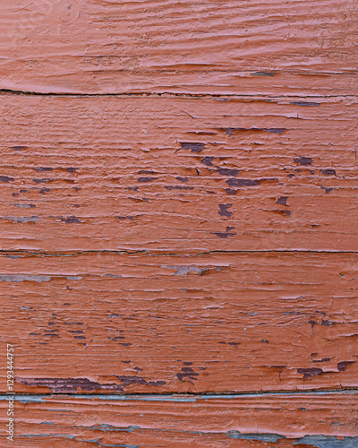 The board is painted orange, close-up. Wood texture. Natural wood background. Old wooden panel, faded and peeling paint. Tree background