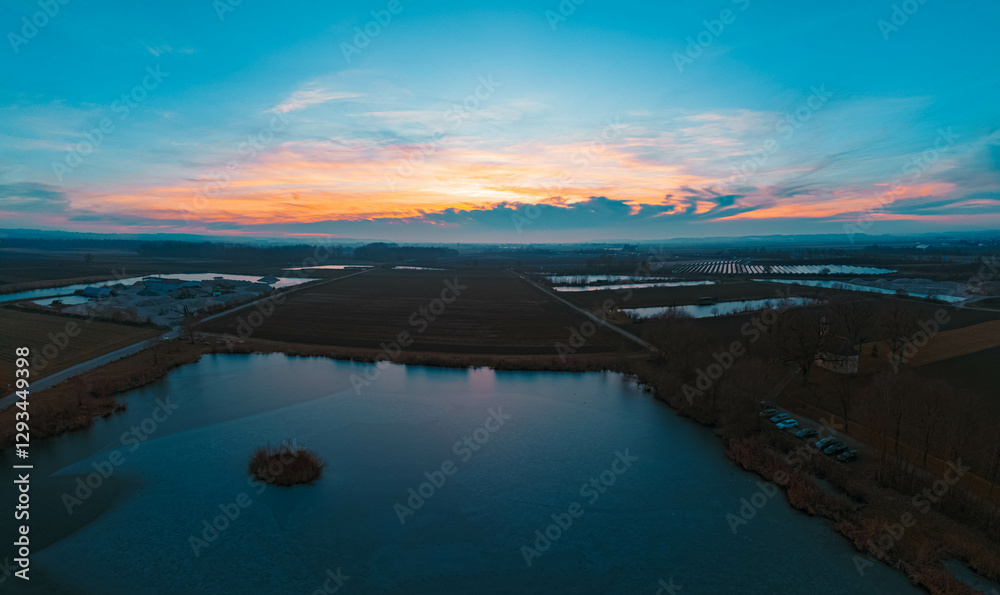 High resolution stitched winter drone panorama captured in flight near sunset or sundowner at Sebastianikirchlein church and ponds near Wallersdorf, Dingolfing-Landau, Bavaria, Germany High resolution stitched winter drone panorama captured in flight near sunset or sundowner at Sebastianikirchlein church and ponds near Wallersdorf, Dingolfing-Landau, Bavaria, Germany