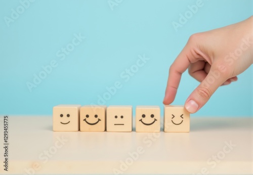Wooden Cubes with Emoticons and Selecting Hand