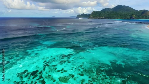 Explore stunning turquoise waters and vibrant coral reefs near a tropical shoreline in a scenic coastal area