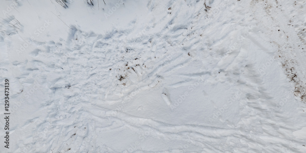 panorama view from above on texture of snow covered road in the winter forest