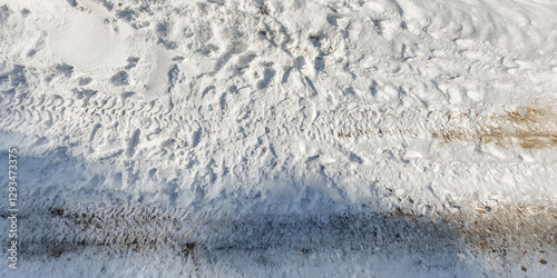 panorama view from above on texture of snow covered road in the winter forest