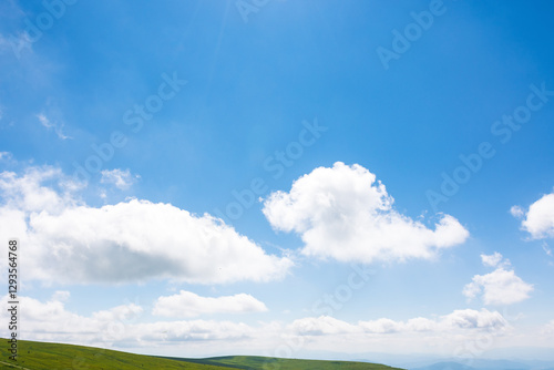Obraz na płótnie white cumulus clouds on a blue sky. horizon above mountain. wonderful nature background of atmosphere condition in day light. bright summer weather forecast. fresh air w salonie