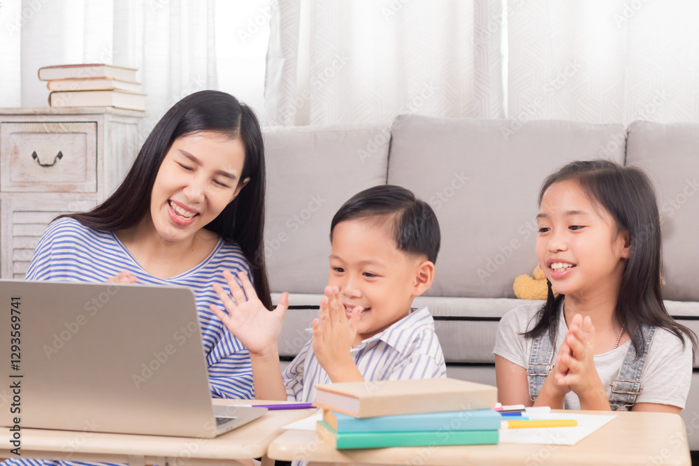 Mother and two children happily using laptop together. Family sitting at table enjoying shared screen time in cozy living room. Laughter and positive emotions, technology use, indoor family bonding.