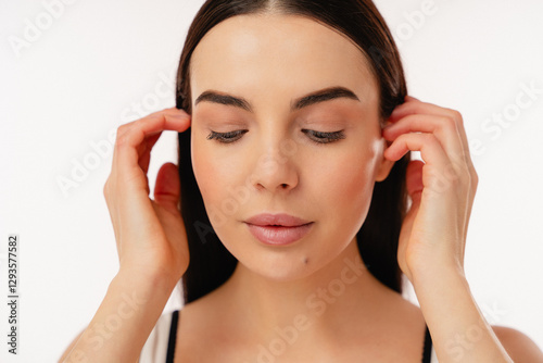 Close-up portrait capturing the serene and introspective expression of a person with eyes closed, showcasing smooth, flawless skin and a calm demeanor, exuding natural beauty and peacefulness.