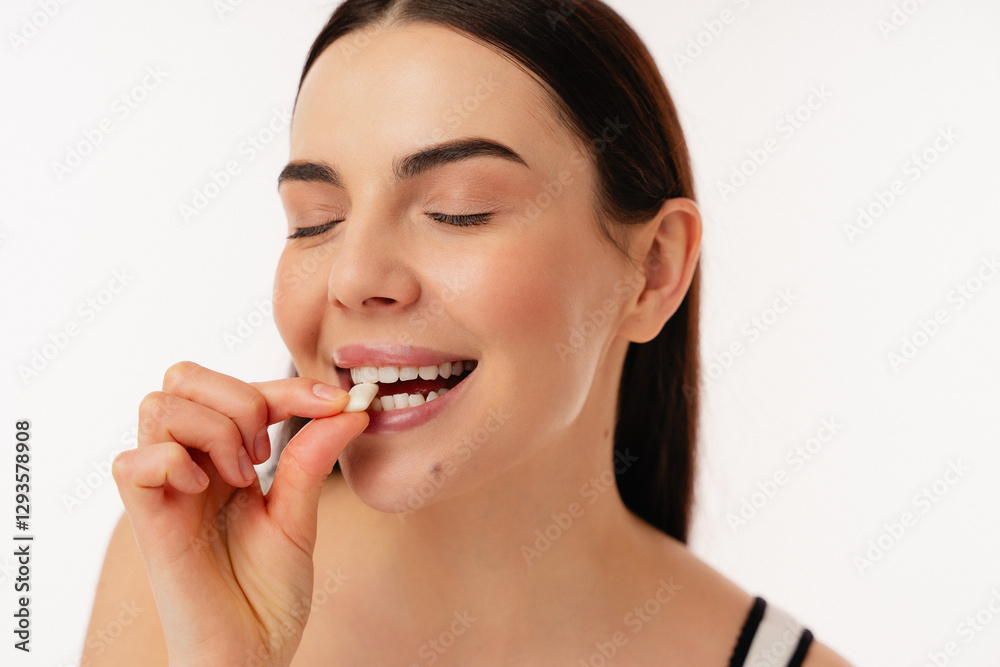 Close-up portrait of a woman smiling with closed eyes holding a snack. The atmosphere conveys feelings of enjoyment, positivity, and wellness, highlighting concepts of health and happiness. Close-up portrait of a woman smiling with closed eyes holding a snack. The atmosphere conveys feelings of enjoyment, positivity, and wellness, highlighting concepts of health and happiness.
