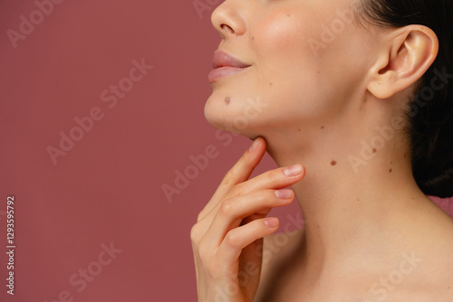 Detailed view of human skin highlighting natural moles and clear complexion with care.