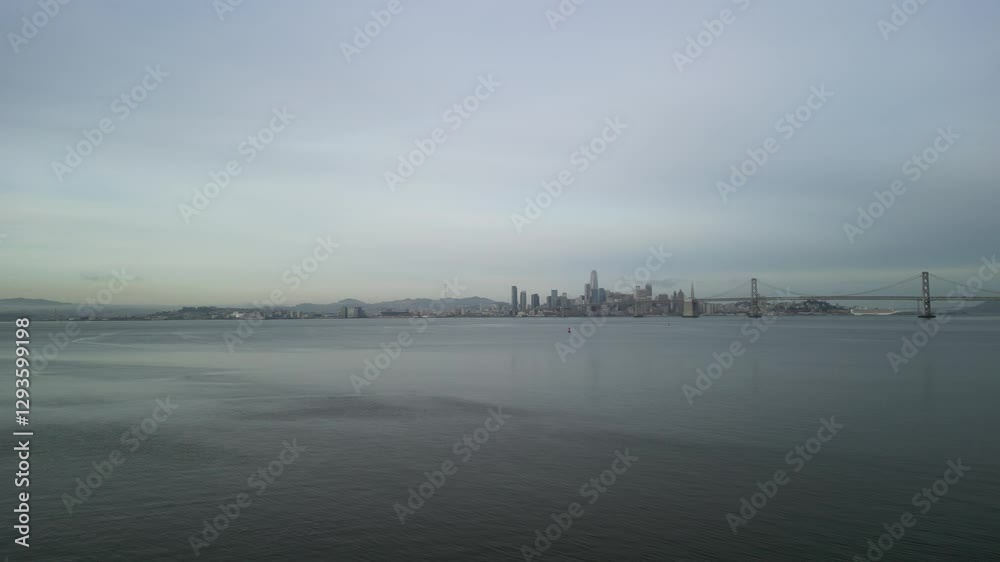 A rotating drone shot displays the Bay Bridge in the distance of the San Francisco Bay. A rotating drone shot displays the Bay Bridge in the distance of the San Francisco Bay.
