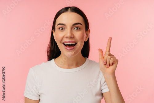 Cheerful person smiling and raising a finger, expressing enthusiasm and creativity against a colorful background.